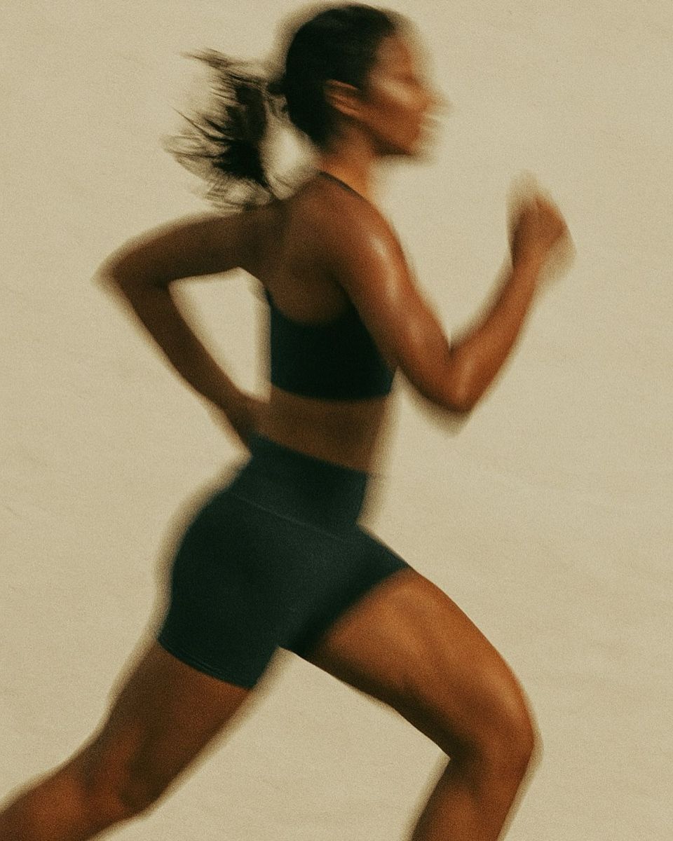 Runner mid-stride, warm editorial light